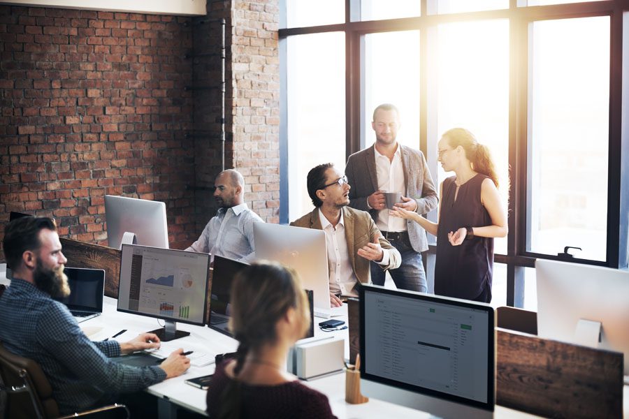 Cyber Liability - Group of Employees Using Computers in their Brick Office